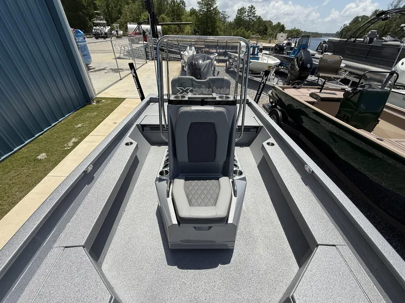 Slide: The Image of 2025 Xpress Hyper-Lift Series H22B boat with center console and seating, docked outdoors. - 5