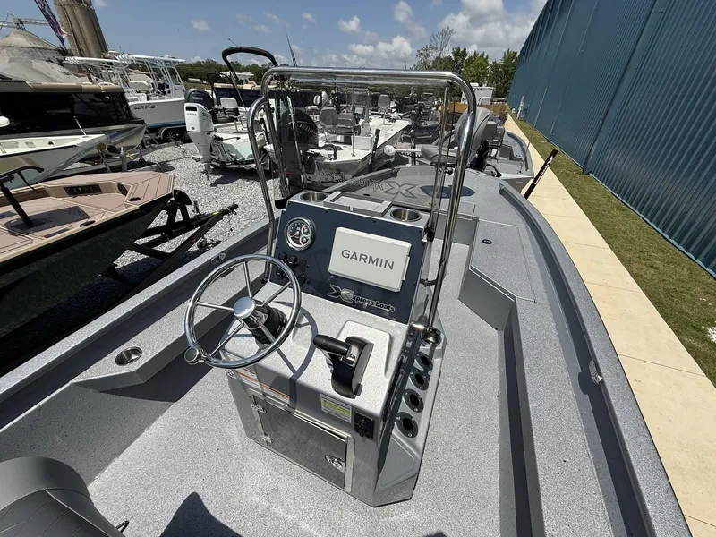 Slide: The Image of 2025 Xpress Hyper-Lift Series H22B boat with Garmin navigation system at a marina. - 6