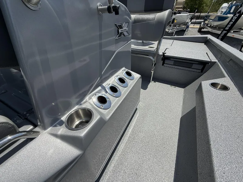 Slide: The Image of 2025 Xpress Hyper-Lift Series H22B boat interior with cup holders and seating. - 9