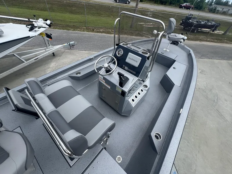 Slide: The Image of 2025 Xpress Hyper-Lift Series H22B boat interior with steering console and seating. - 15
