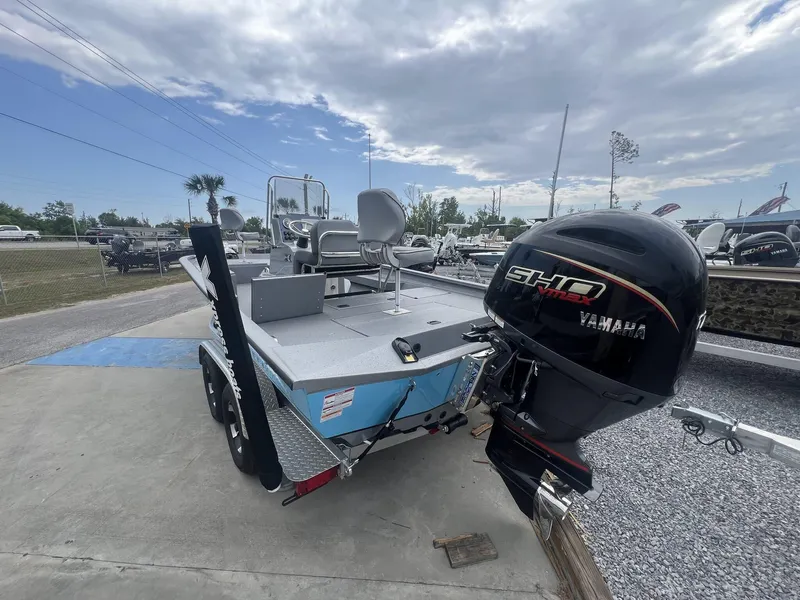 Slide: The Image of 2025 Xpress Hyper-Lift Series H22B boat with Yamaha engine, parked outdoors under cloudy sky. - 5