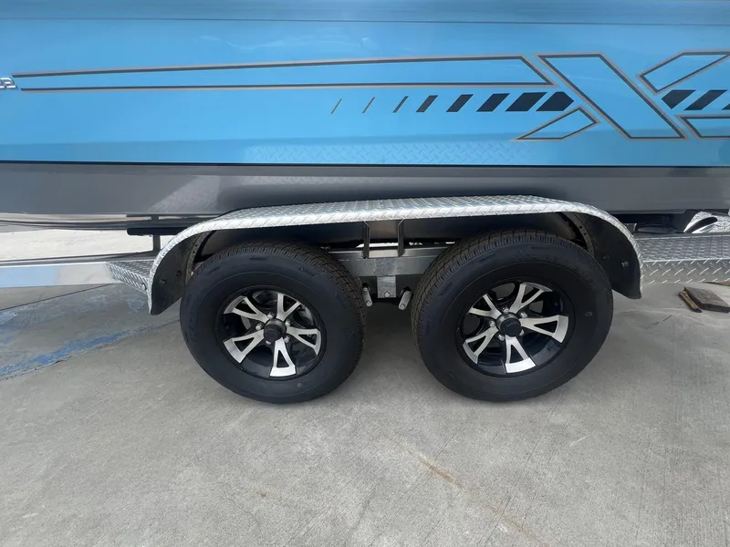Slide: The Image of 2025 Xpress Hyper-Lift Series H22B boat trailer with dual black alloy wheels. - 7