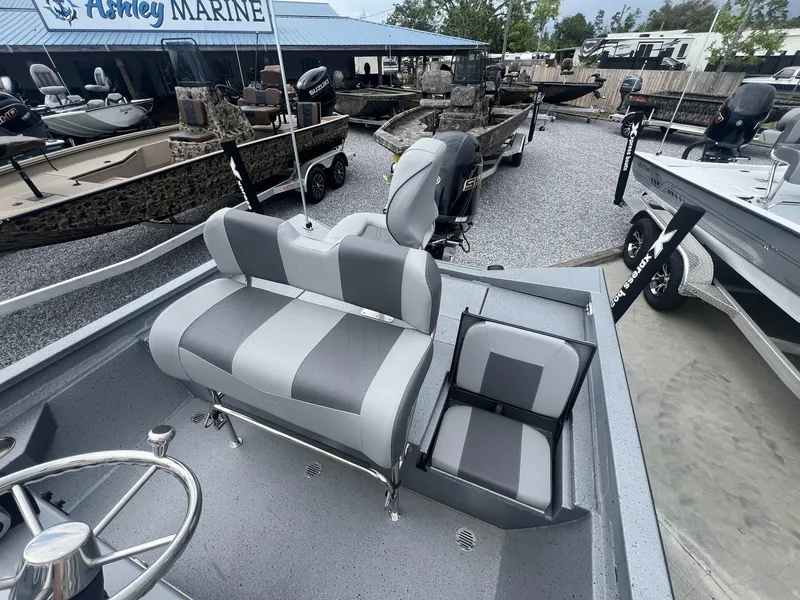 Slide: The Image of 2025 Xpress Hyper-Lift Series H22B boat interior with gray seating at Ashley Marine. - 8