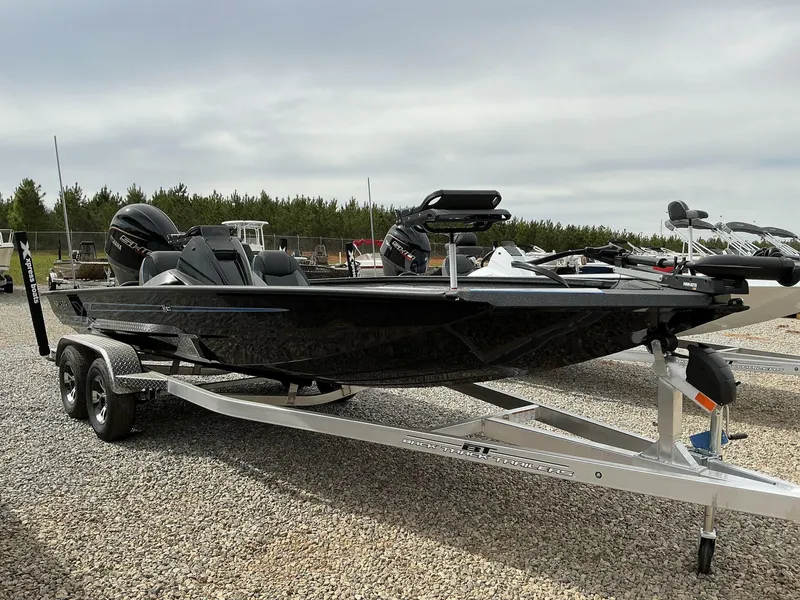 Slide: The Image of 2025 Xpress Hyper-Lift Crappie Series H20 boat on trailer, parked outdoors. - 1