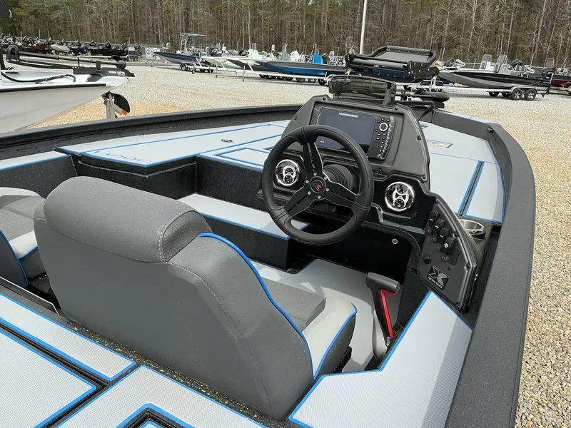 Slide: The Image of 2025 Xpress Hyper-Lift Crappie Series H20 CRAPPIE boat interior with steering console and seating. - 5