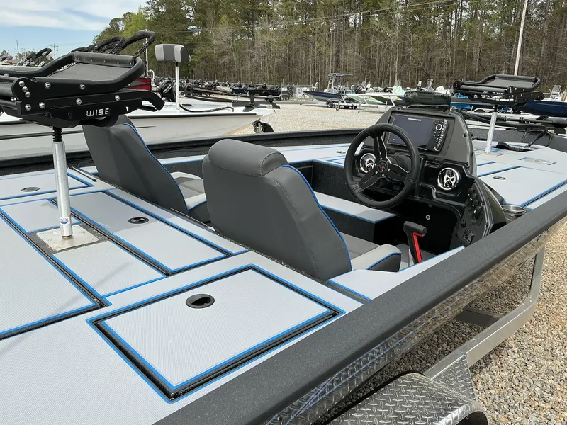 Slide: The Image of 2025 Xpress Hyper-Lift Crappie Series H20 boat interior with steering console and seating. - 7
