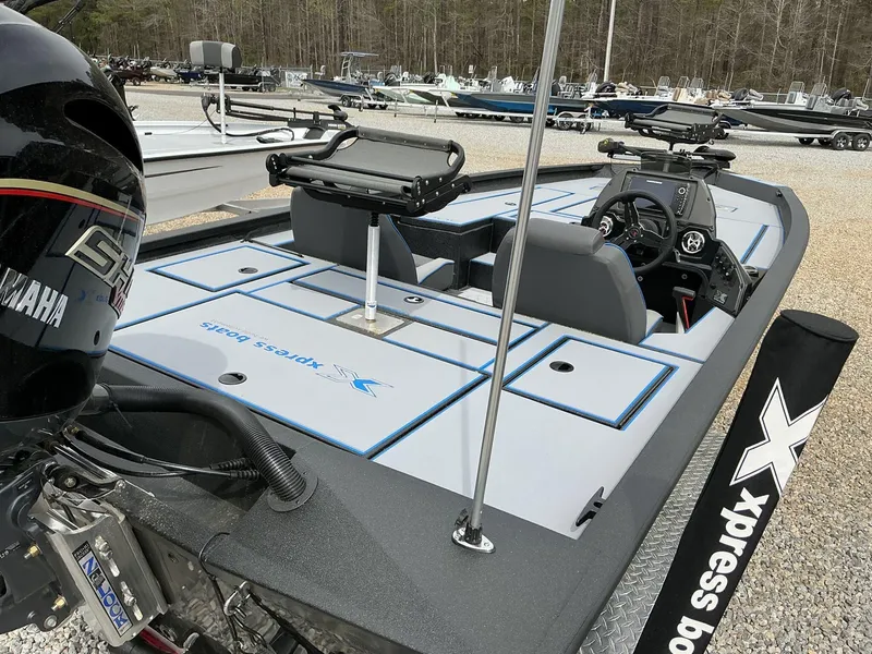 Slide: The Image of 2025 Xpress Hyper-Lift Crappie Series H20 boat with Yamaha engine, parked outdoors. - 8