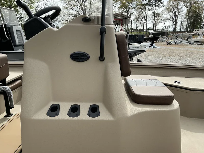 Slide: The Image of 2025 Excel Bay Pro 203 Elite boat console with seating, outdoors. - 5