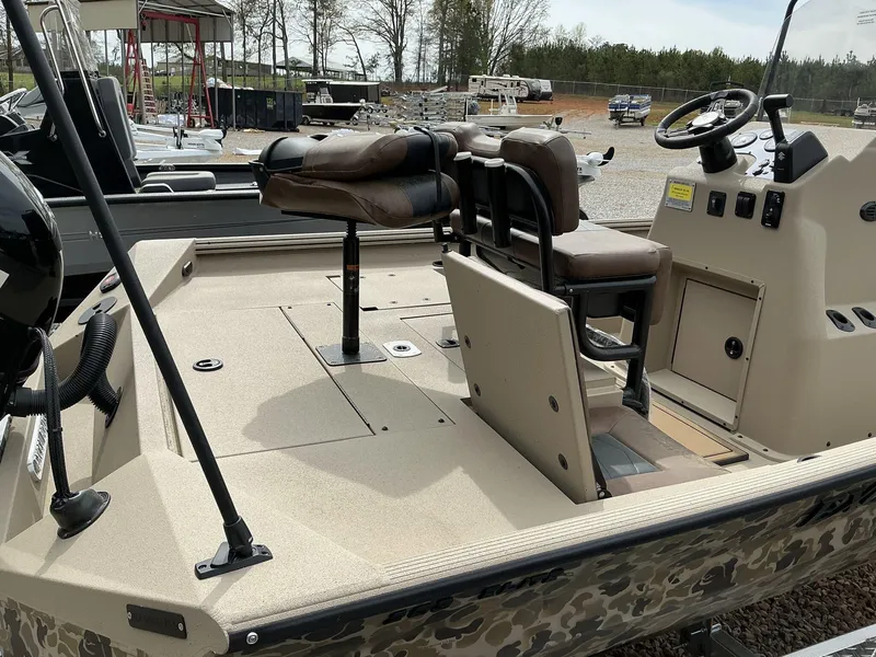 Slide: The Image of 2025 Excel Bay Pro 203 Elite boat interior with seating and steering console. - 8