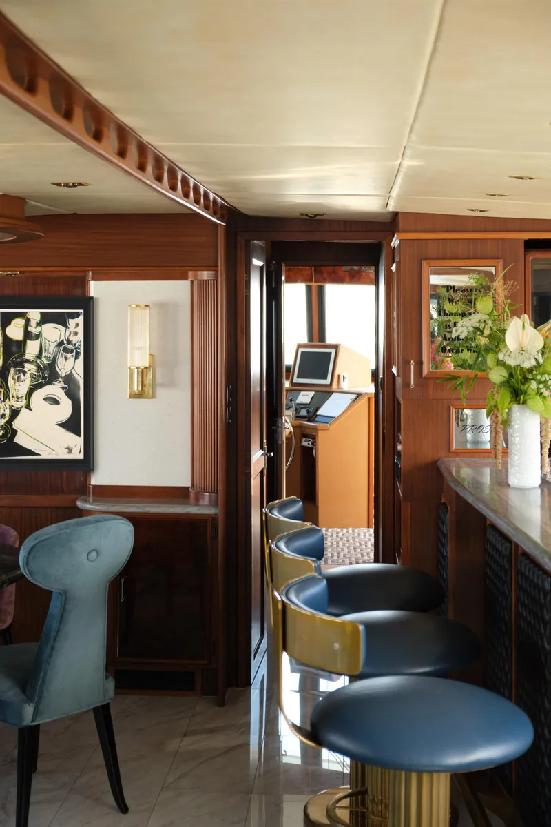 Slide: The Image of Interior of a 1981 Hatteras Motor Yacht with elegant seating and decor. - 13