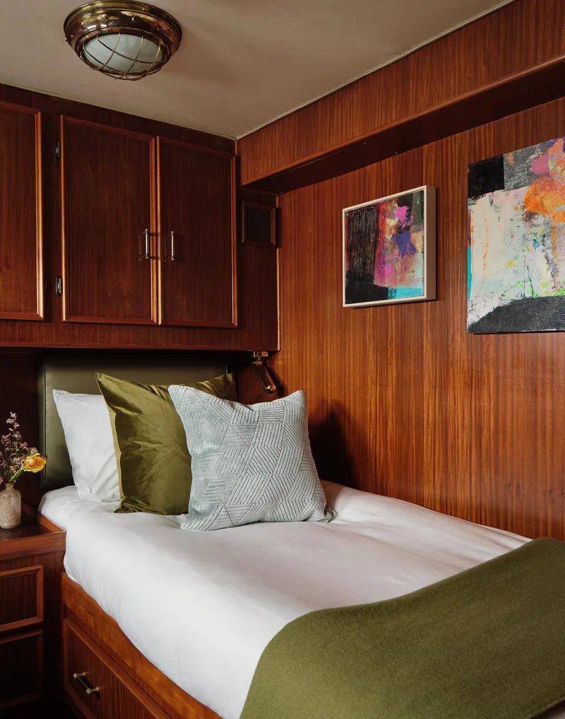 Slide: The Image of Cozy cabin interior of 1981 Hatteras Motor Yacht with wood paneling and modern decor. - 20