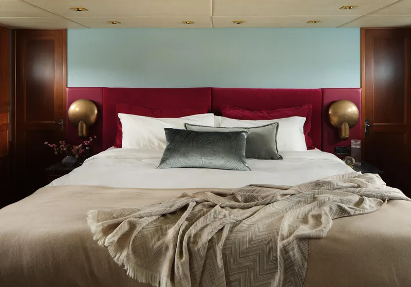 Slide: The Image of Luxurious bedroom interior on a 1981 Hatteras Motor Yacht, featuring elegant bedding and decor. - 22