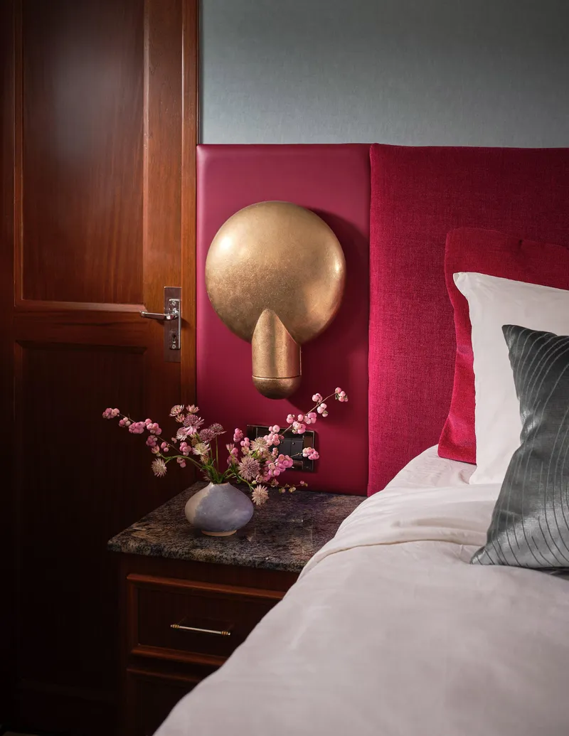 Slide: The Image of Luxurious bedroom interior on 1981 Hatteras Motor Yacht with red accents and elegant decor. - 24