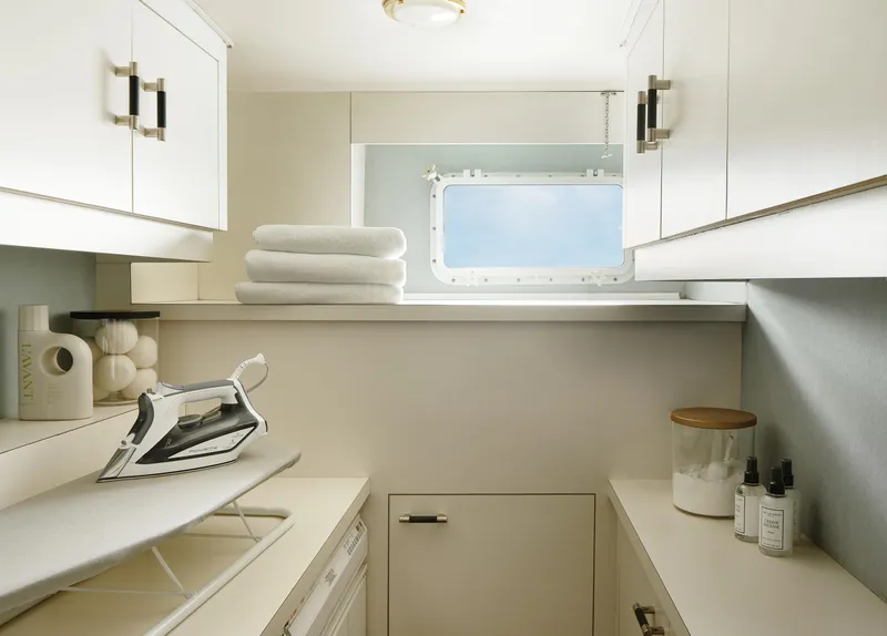 Slide: The Image of Laundry room on 1981 Hatteras Motor Yacht with ironing board and ocean view window. - 26
