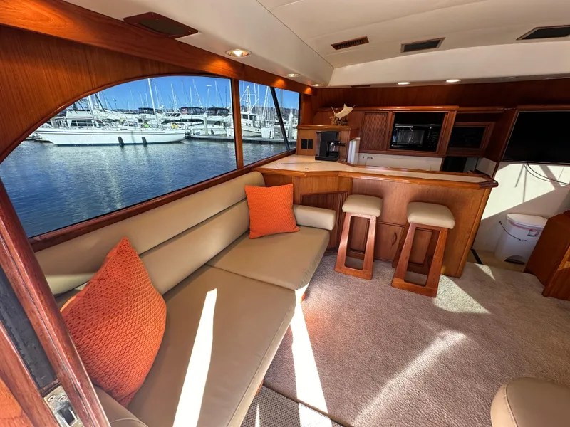 Slide: The Image of Luxurious 1988 Buddy Davis Convertible yacht interior with plush seating and marina view. - 10