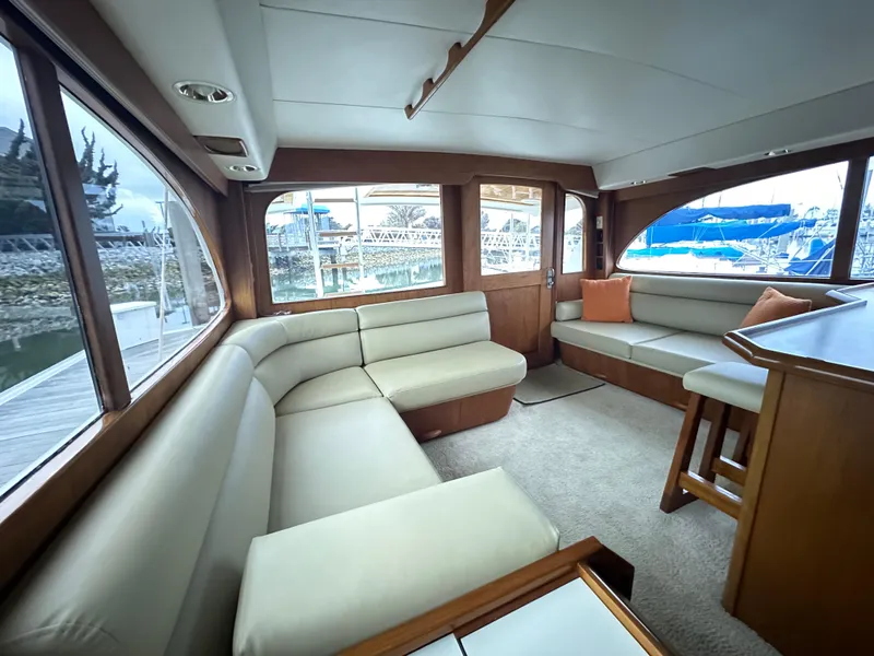 Slide: The Image of Luxurious interior of a 1988 Buddy Davis Convertible yacht with plush seating and wooden accents. - 12