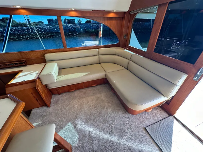 Slide: The Image of Luxurious interior of a 1988 Buddy Davis Convertible yacht with plush seating and large windows. - 15