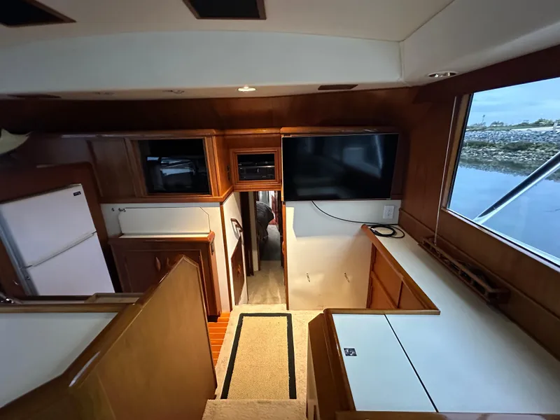 Slide: The Image of Interior of 1988 Buddy Davis Convertible yacht with wood cabinetry and large window view. - 17