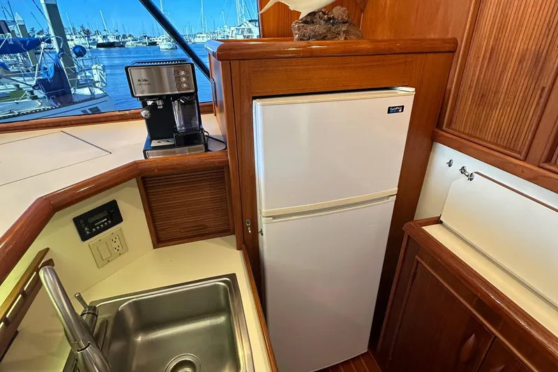 Slide: The Image of 1988 Buddy Davis Convertible yacht kitchen with sink, fridge, and coffee maker. - 19