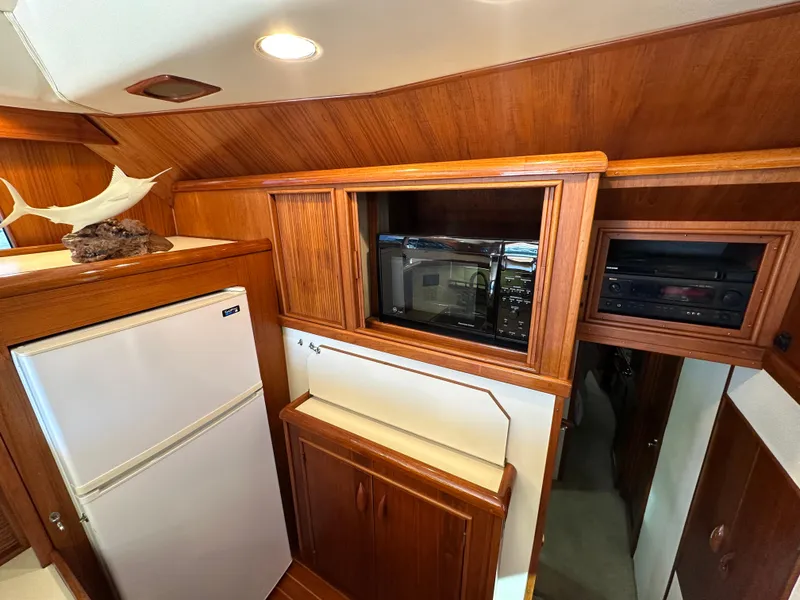 Slide: The Image of 1988 Buddy Davis Convertible yacht interior with wood cabinetry, microwave, and refrigerator. - 20