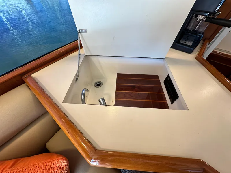 Slide: The Image of 1988 Buddy Davis Convertible yacht interior with built-in sink and wooden accents. - 22