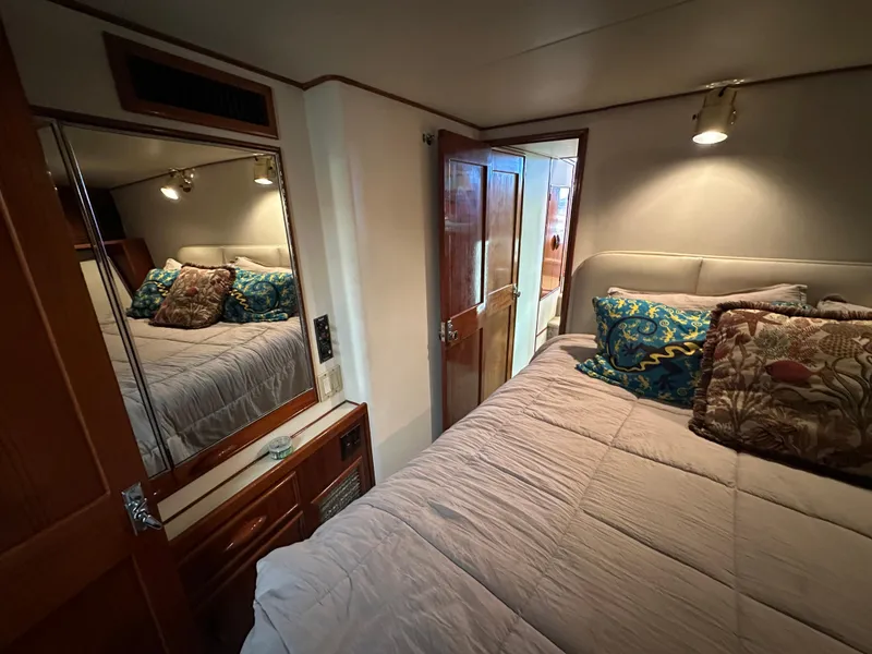 Slide: The Image of Cozy bedroom in 1988 Buddy Davis Convertible yacht with plush bedding and mirrored closet. - 27