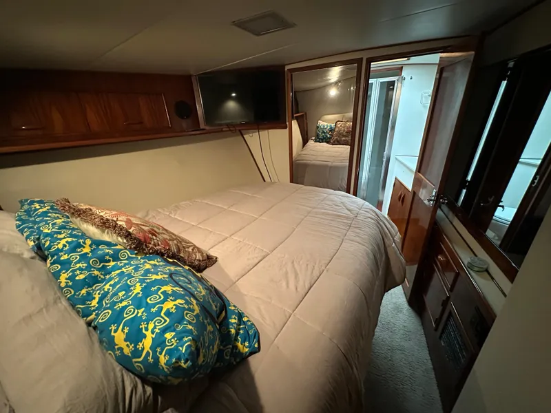 Slide: The Image of Cozy bedroom in 1988 Buddy Davis Convertible yacht with plush bedding and wood accents. - 28