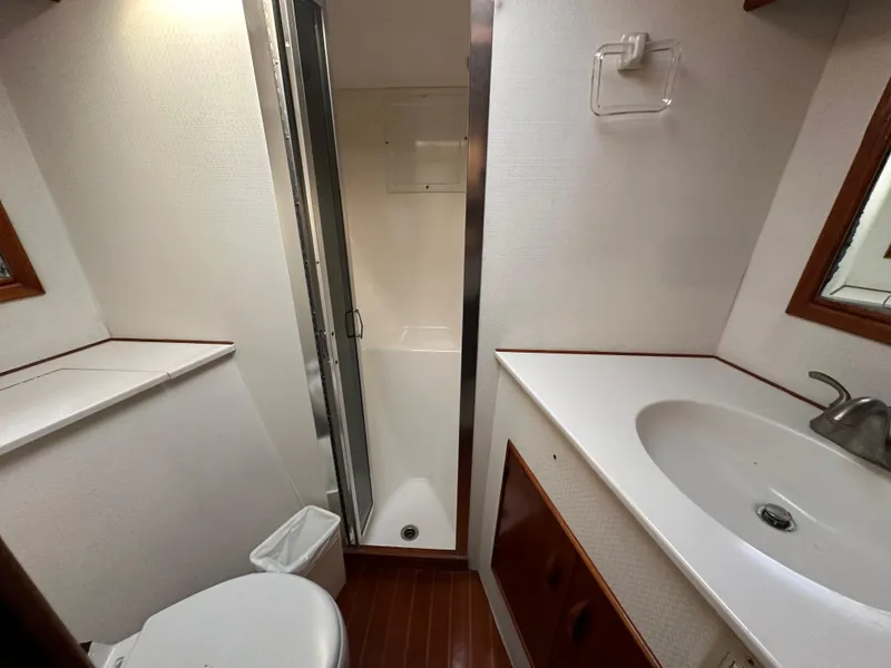 Slide: The Image of 1988 Buddy Davis Convertible yacht bathroom with shower, sink, and toilet. - 31