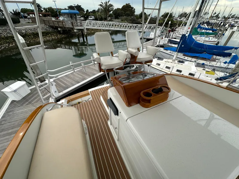 Slide: The Image of 1988 Buddy Davis Convertible yacht with seating and helm, docked at a marina. - 7