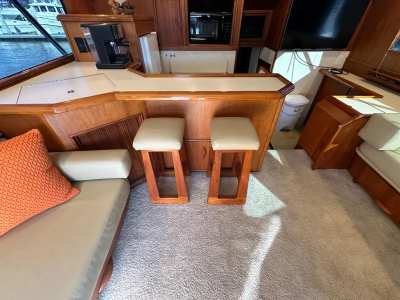 Slide: The Image of Interior of 1988 Buddy Davis Convertible yacht with bar stools and cozy seating area. - 8