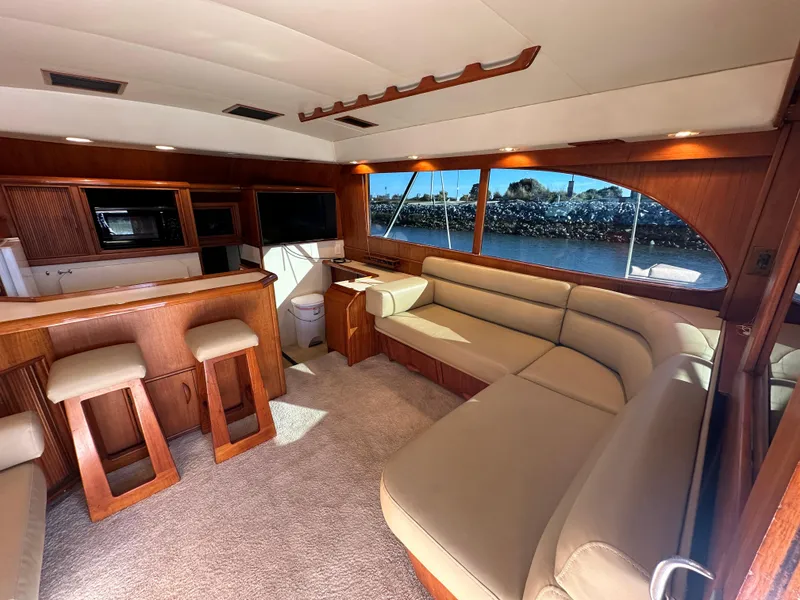 Slide: The Image of Luxurious 1988 Buddy Davis Convertible yacht interior with elegant wood finishes and spacious seating. - 9
