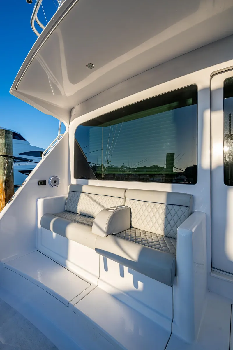 Slide: The Image of 2005 Viking 52 Convertible yacht with cushioned seating and sleek design. - 11