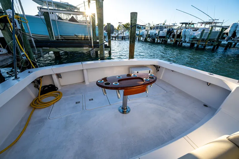 Slide: The Image of 2005 Viking 52 Convertible yacht deck with fishing station, docked at marina. - 12