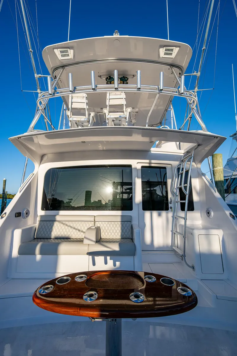 Slide: The Image of 2005 Viking 52 Convertible yacht with fishing rod holders and upper deck seating. - 13