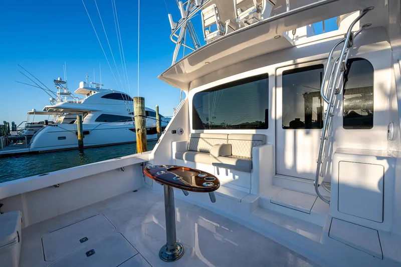 Slide: The Image of 2005 Viking 52 Convertible yacht docked, featuring spacious deck and seating area. - 15