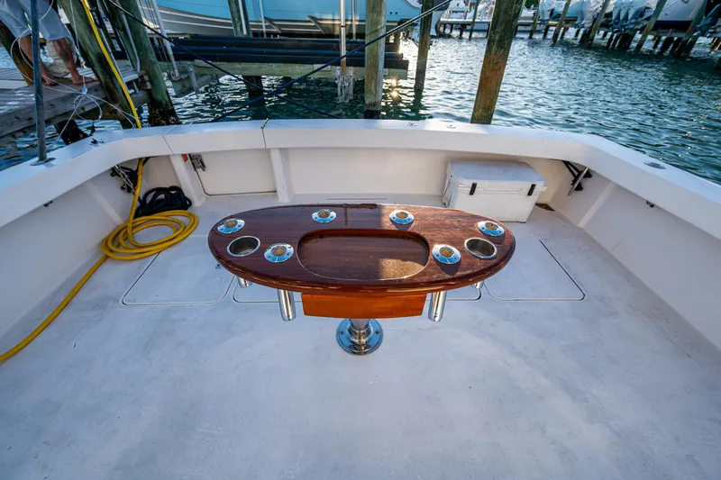 Slide: The Image of 2005 Viking 52 Convertible yacht deck with fishing rod holders and ocean view. - 16
