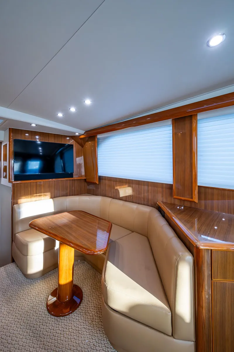 Slide: The Image of Luxurious interior of 2005 Viking 52 Convertible yacht with elegant seating and wood finishes. - 18