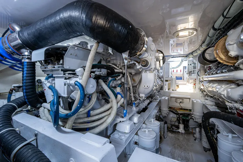 Slide: The Image of Engine room of 2005 Viking 52 Convertible yacht, showcasing complex machinery and piping. - 25
