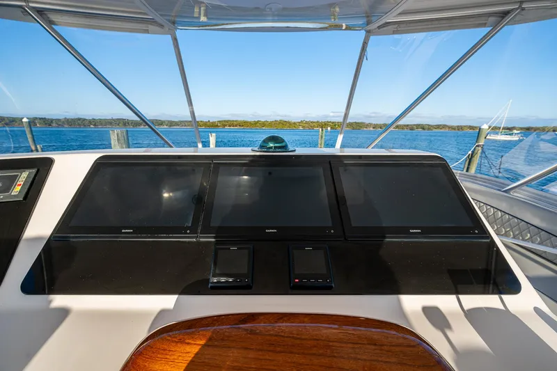 Slide: The Image of Helm of 2005 Viking 52 Convertible yacht with navigation screens and ocean view. - 33