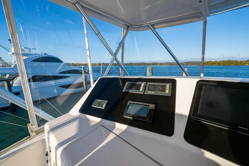 Slide: The Image of Helm of 2005 Viking 52 Convertible yacht with navigation equipment, docked by the water. - 34
