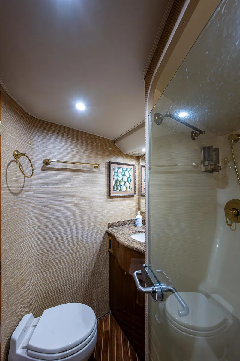 Slide: The Image of 2005 Viking 52 Convertible yacht bathroom with shower, toilet, and vanity. - 39