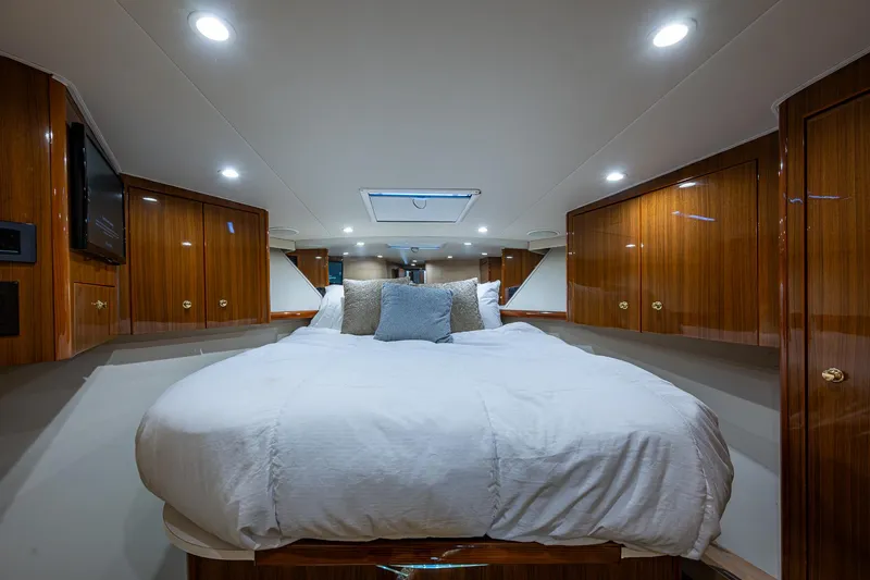 Slide: The Image of Luxurious bedroom interior of 2005 Viking 52 Convertible yacht with wood cabinets and skylight. - 40