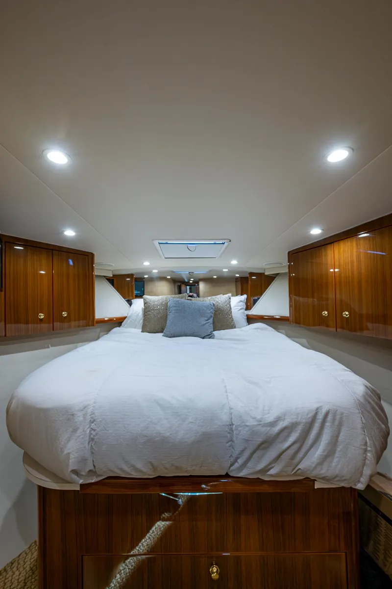 Slide: The Image of Luxurious bedroom interior of 2005 Viking 52 Convertible yacht with elegant wood cabinetry. - 42