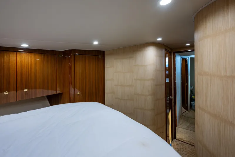 Slide: The Image of Interior of 2005 Viking 52 Convertible yacht, featuring wood paneling and modern lighting. - 45