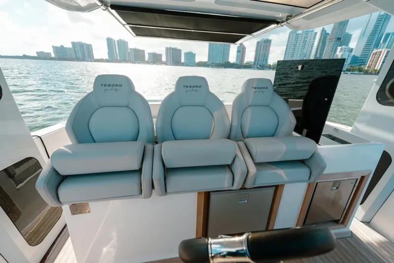 Slide: The Image of 2022 Tesoro T40 Outboard boat seats with city skyline in the background. - 11