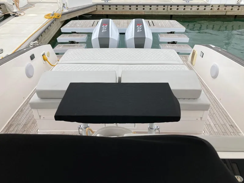 Slide: The Image of 2022 Tesoro T40 Outboard boat with dual engines docked at a marina. - 12
