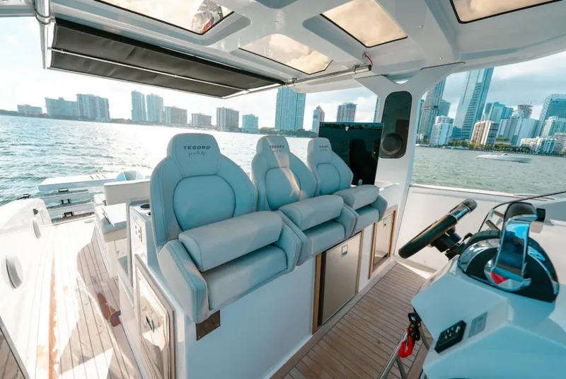 Slide: The Image of 2022 Tesoro T40 Outboard boat interior with luxury seating, city skyline in background. - 13