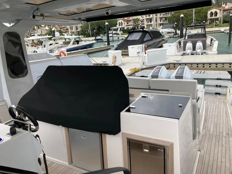 Slide: The Image of 2022 Tesoro T40 Outboard boat docked at marina with covered seating area. - 16