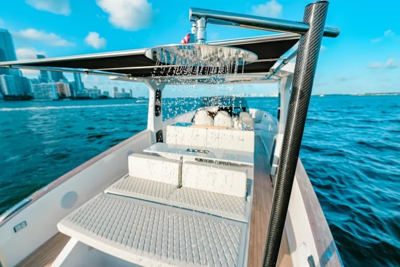 Slide: The Image of 2022 Tesoro T40 Outboard boat with shower, cruising on blue ocean near city skyline. - 17