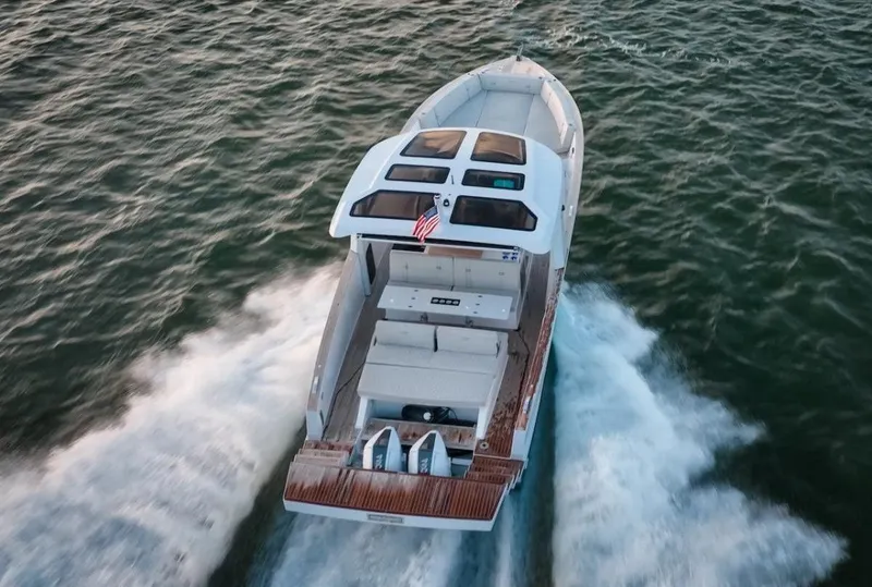 Slide: The Image of 2022 Tesoro T40 Outboard boat cruising on open water, aerial view. - 2